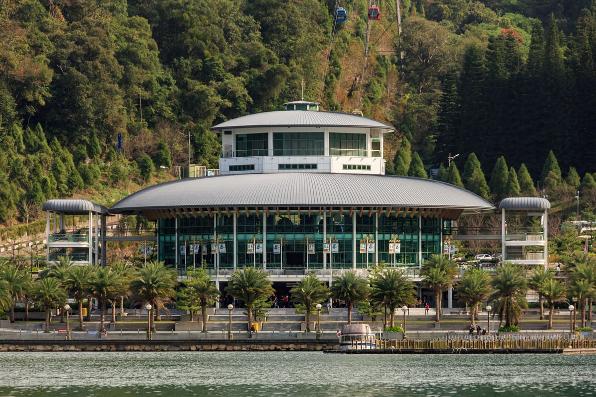 A Sun Moon Lake Ropeway gondola above the forested ridge